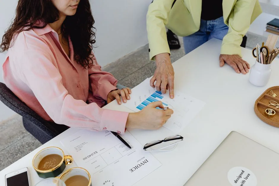 Business professionals working together on financial data analysis in a modern office environment.